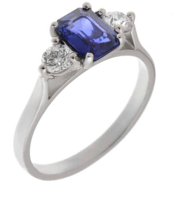 Olivia emerald cut blue sapphire and round diamond trilogy ring