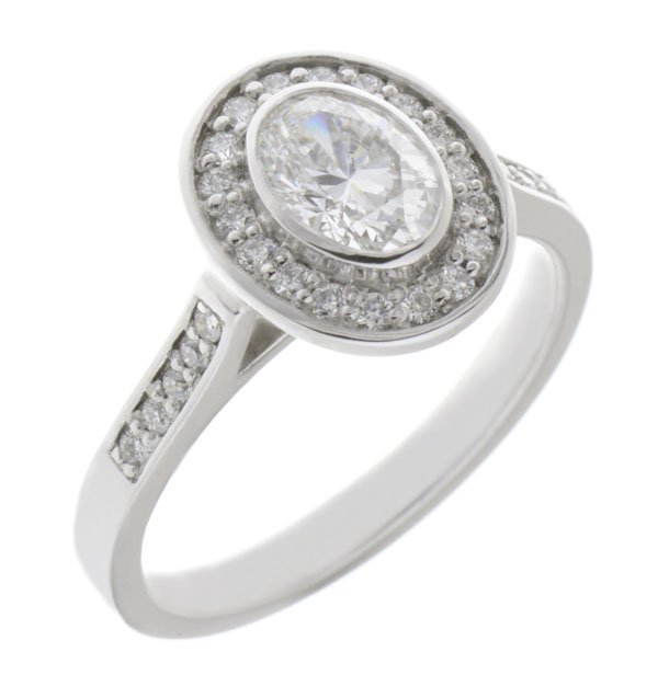 Classic rubover set oval diamond with round diamond halo engagement ring